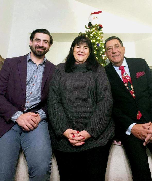 Dr. Brandon Parrone, pictured at left, with his parents, Lisa and Mark Parrone.