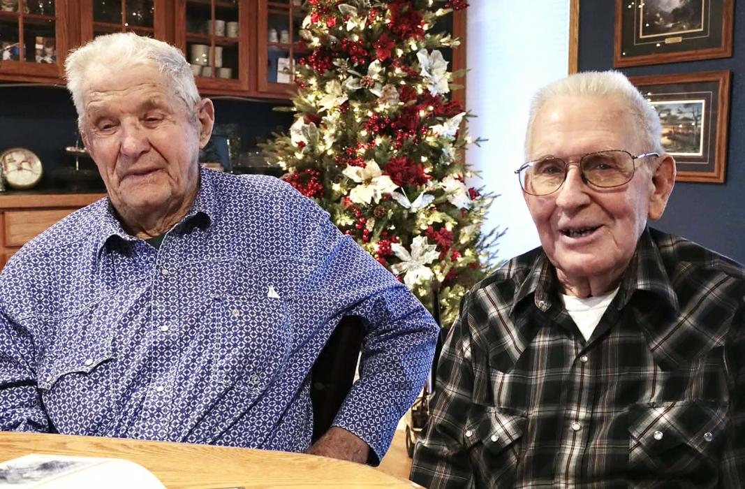 Gilbert Witte and Richard “Dick” Steifel - Reminiscing over their photos of the Korean War Photo by Tina Boone
