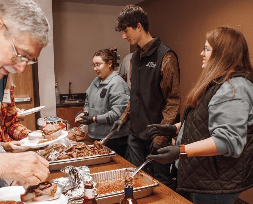 Brooklyn Coyle, Reeves Witte and Shawna Houdek serving FFA Chapter’s Heart City Beef to the conference group.