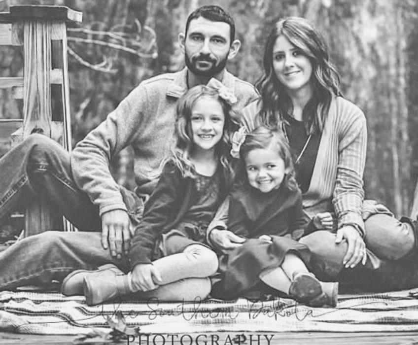 Pictured are Brittany Benzing and her family; husband Matt, and daughters Haile and Lauren.