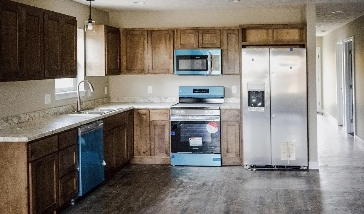 The stainless steel appliances are still covered in protective wrap rendering them turquoise. The cabinetry was custom built by Grant Bitner, a local craftsman.