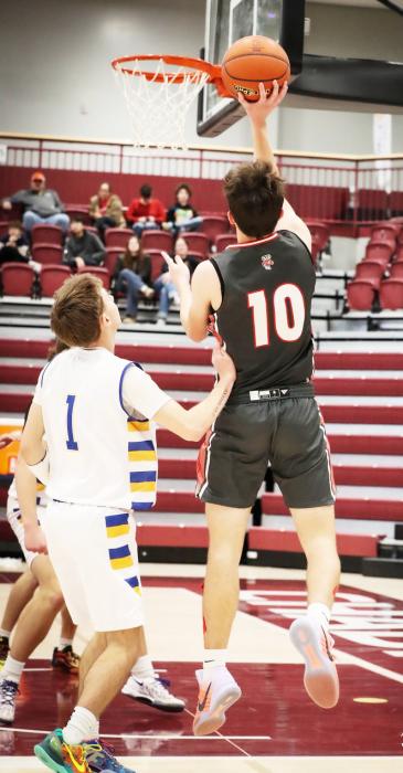 Caden Stankoski Senior lay up. Photo by Nina Maria Nelson
