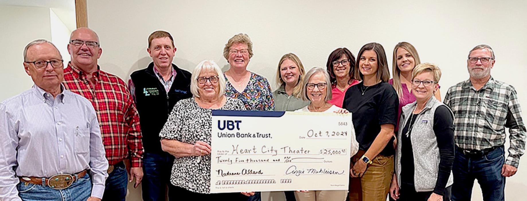 Pictured from L to R: SAF board member Monty Neiffer, HCT board member Mark Hagge, SAF board member Christopher Douglas, HCT board member and UBT bank manager Nadeane Allard, SAF board President Kim Marlatt, HCT board members Jana Bitner, Chris Bitner, Jerilyn Colburn, HCT board President Danielle Arganbright, SAF board member Talia Benson, HCT board member Shelly Henderson, and SAF board member Steve Brown, accepting the grant from Union Bank and Trust.