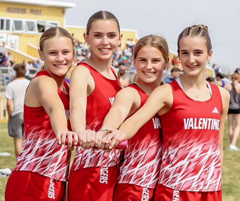 4x100 relay team is pictured from R to L: Joni Cox, Maeli Patterson, Danika Janssen, and Paige Springer who earned first place. Photo by Nina Maria Nelson