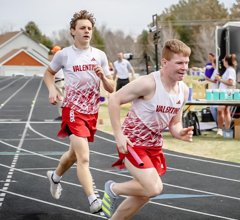 A relay handoff between Beebout and Utecht. Photo by Nina Maria Nelson