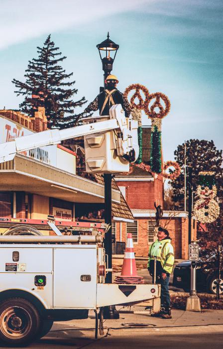 One of the crews putting up Christmas decorations for the upcoming celebration of Jesus’ birth! Stetson Kaufman in the bucket and coworker Dustin Oliver. Photo by Tina Boone