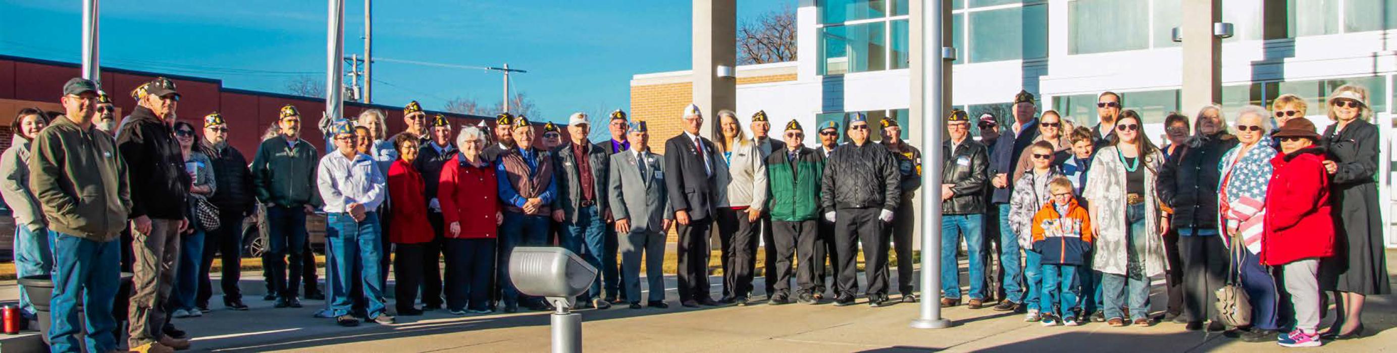 A sunny beginning to the District 1 Convention held in Valentine, NE. A flag raising ceremony was held at Veterans Square before the convention began at the Vets Club. Quite an assemblage of people with one common and noble goal - helping veterans. Photo by Tina Boone