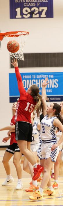Annalena Nelson goes for a layup on the left. Photo by Nina Maria Nelson
