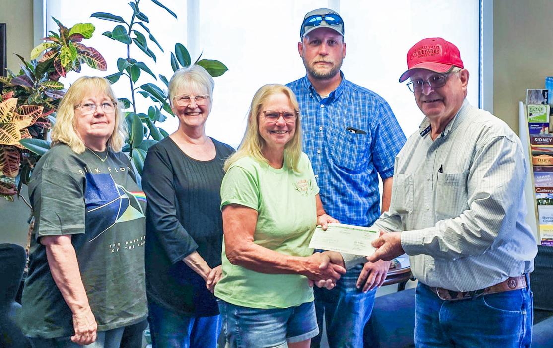 Pictured are back row, from L to R: Vonnie Seidel, Berniece Rhodes, Andy Dawson. Front row, L to R: Diette Glen receiving check from Greg Nollette. Photo by Regina Osburn