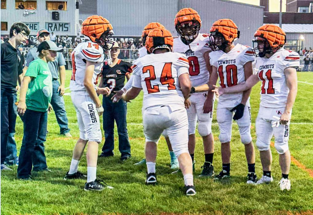 CK junior Wesley Willert #24 pumps up his teammates CK freshman Connor Simmons #14, Alex Barnes #40, Knox Wobig #10, and CK junior Tripp Hill #11 prior to the kickoff against the Crawford Rams in Crawford, NE. Photo by Carly Wobig