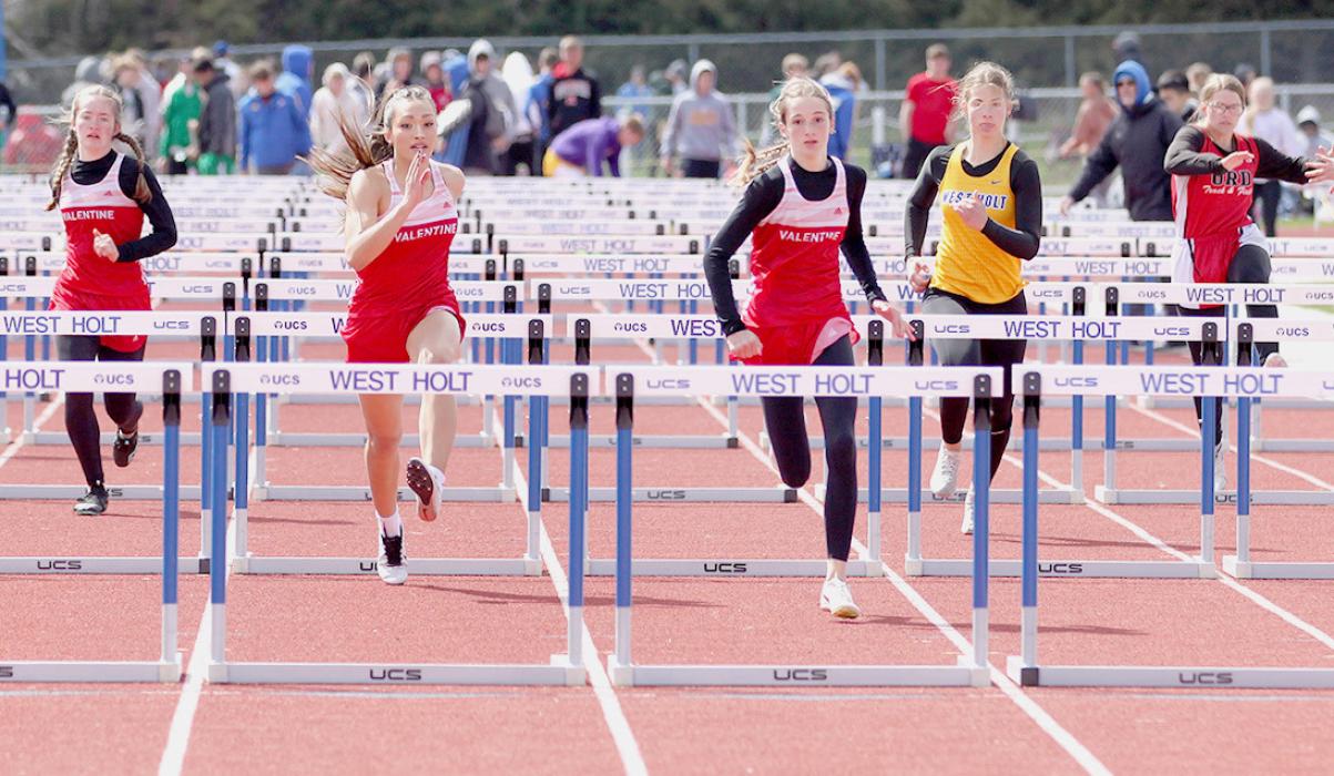 Aubrey Benson, Ariana Blume and Page Sprenger compete in the 100 Hurdles. Photos by Amanda Long