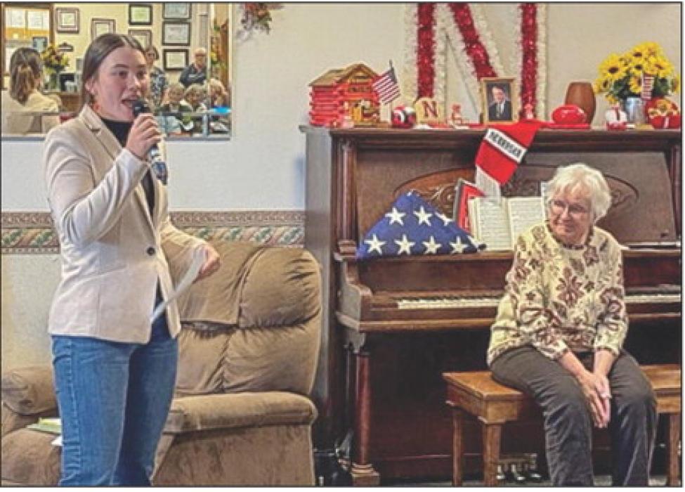 Ella Brennemann shares her Bronze Medal speech she wrote for the American Legion Oratorical Contest. Yvonne Hollenbeck, at right, played piano for the patriotic songs that were enjoyed at Cherry Hills.