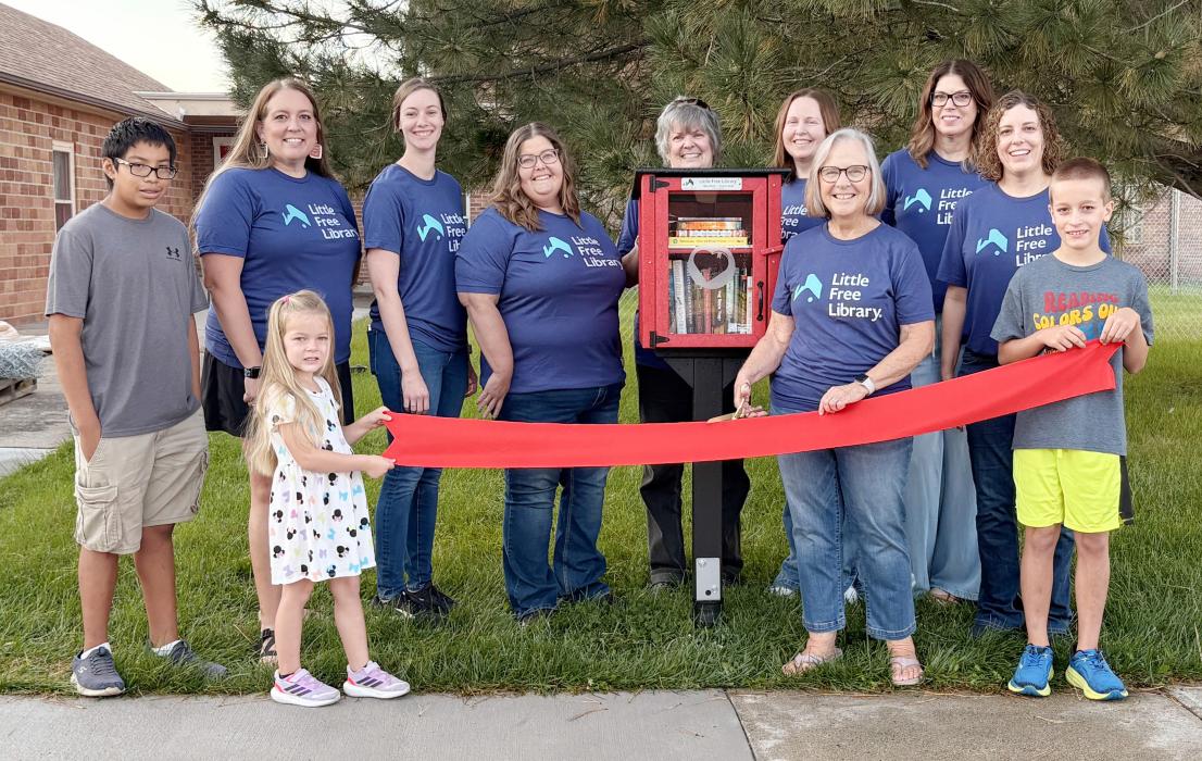Pictured at the Little Free Library Ribbon Cutting are back row, L to R: Andy Krueger, Lindsey Little, Nichole Garwood, Rita O’Kief, Marit Kaiser, Carrie Graham, Nicole Osnes. Front row, L to R: Luke Osnes, Hannah Krueger, Chris Bitner, and Noah Krueger. Not pictured, Patty Tinant and Anne Quigley.