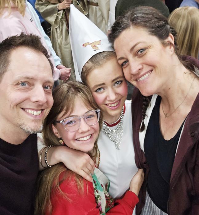 Pastor Caleb Schaller with two of his four daughters, sophomore Margaret, senior Carmen, and his beautiful wife, Jennifer.