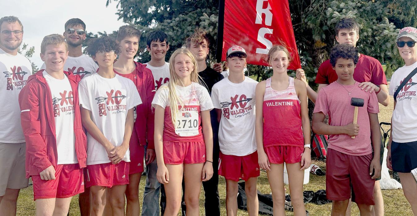 The Badger Cross Country Team are pictured from L to R: Head coach Alex Jensen, Isaac Utecht, Devlin Welch, Tanner Two Strike, Landen Mooney, Allen Ward, Christen Larson, Boone Jespersen, Deklin Titus, Paige Sprenger, Jackson Huggins (front), Duncan Mosner (back), and Assistant Coach Candi Cronin.