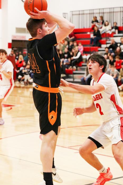 Hesston Fay #24 of Cody shooting, as defense Badger Trace Buechle #2 aims to stop that.