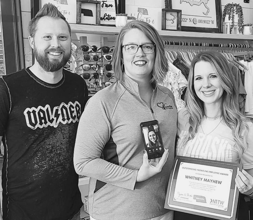 Pictured are from L to R: Phil Mayhew, Regina Osburn, Callie Austad on the phone, and Whitney Mayhew. Photo by Laura Vroman