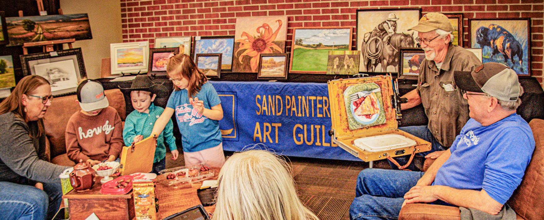 Joan Swim, president of the Sand Painters Art Guild, along with other members are getting youth interested in art.