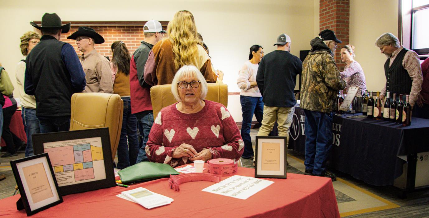 Inside Sandhills State Bank, we have Nadeane Allard selling tickets for the wine tasting.