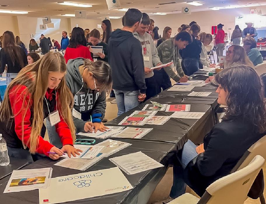 Students stop at one of 13 stations to balance their new life situation budget in an Intro to Life 2025.