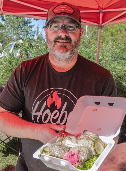 Jason Hoebelheinrich showcases chicken breast covered in a secret sauce.