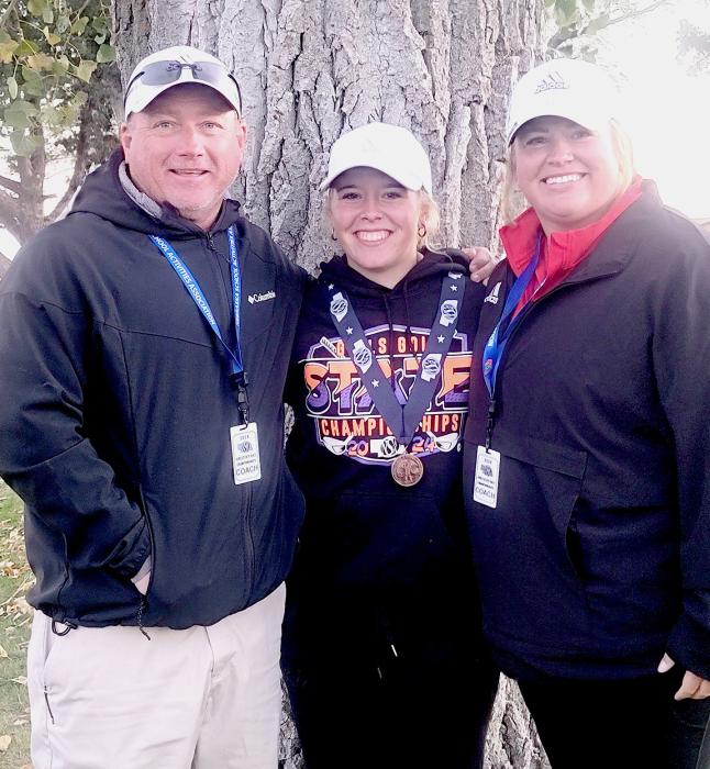 Coach Muirhead, Tierney Miller who placed 12th individually, and Coach Houdek.