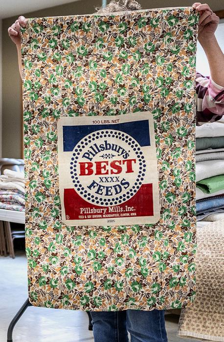 A colorfully printed feed sack in green, mustard and brown was used to make a lovely apron, dress, or quilt pieces...and the label soaked off would become underwear.