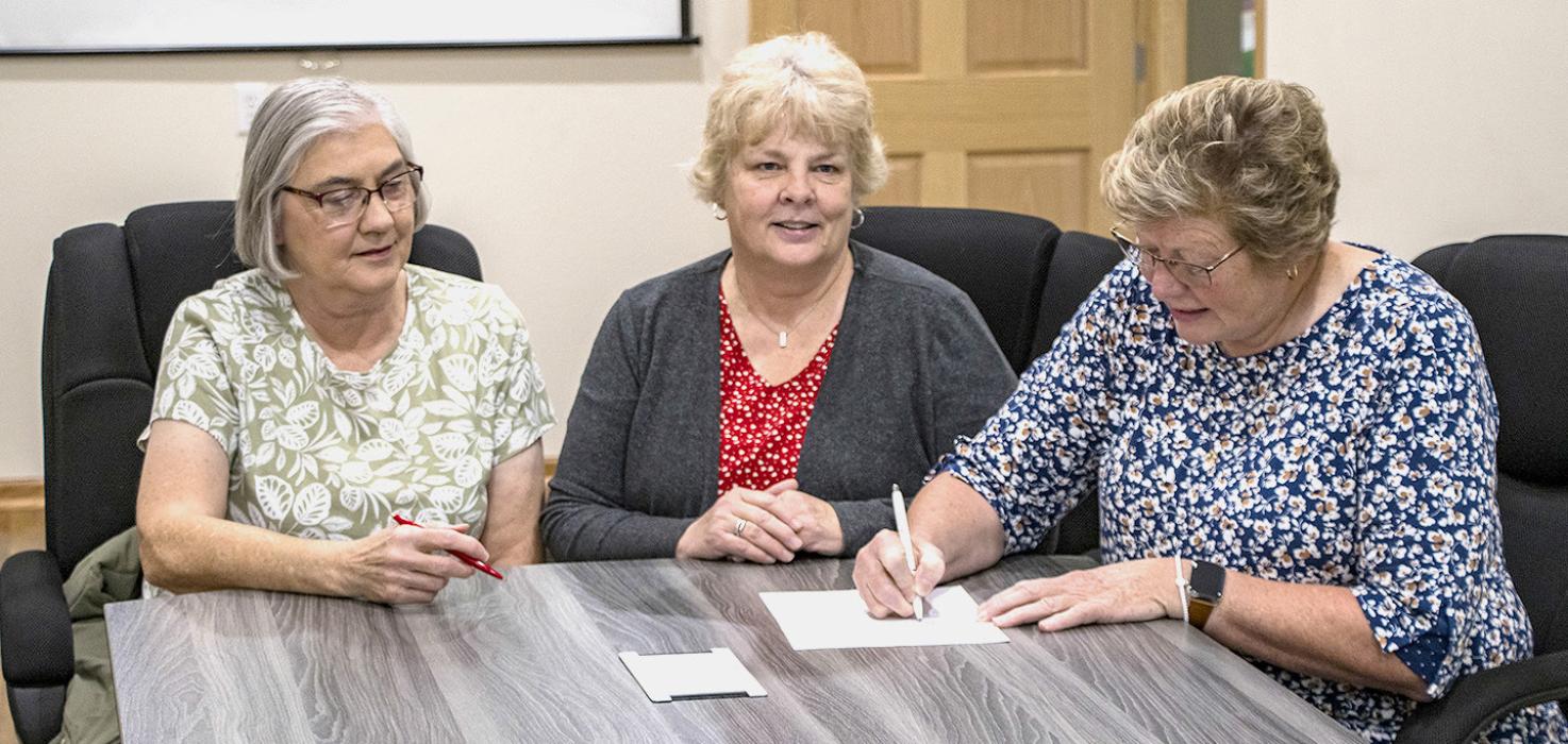 Pictured are Louise Heinert, Carolyn Moore, and Kim Marlatt signing the paperwork to allow the Sandhills Area Foundation to be a conduit for tax free donations to the Sparks Church to help with its refurbishment. Photos by Laura Vroman