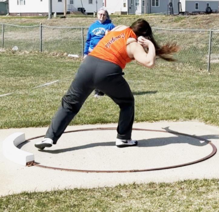 CK freshman, Aubryanna Schmit in mid-throw during competition at the Bassett Track and Field Invite. Photo by Bentley Jenkins