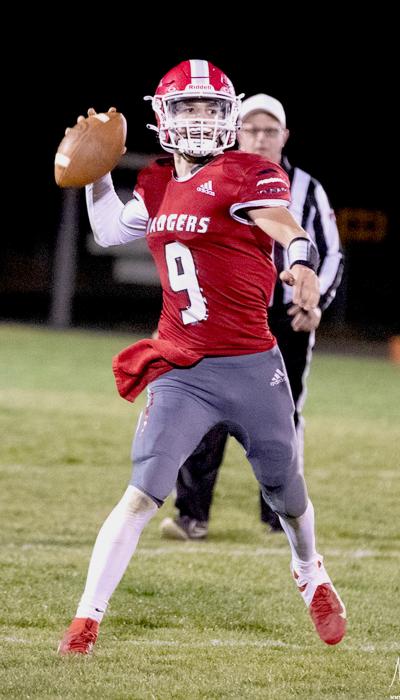 Quarterback Trace Buechle #9 passing the ball in the game against Kearney Catholic High School.