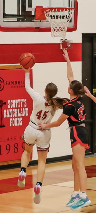Pictured at above is Annalena Nelson #45 with a lay up. Pictured at right is Joni Cox #10 with a lay up. Photos by Nina-Maria Nelson