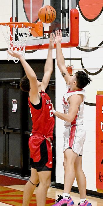 Andon Olson escapes a Mc-Cook defender to score 2 points. Photo by Harvey Dean Fast Horse