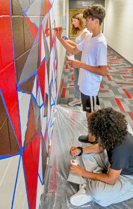 Pictured front to back, King-Zavien Brown, Crew Patterson, and Marin Cronin, students making their mark. Photo by Tina Boone