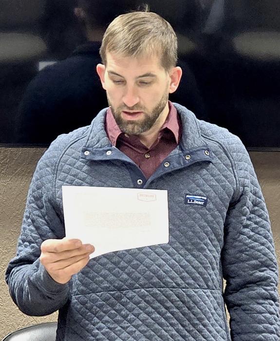 Max Eggert read the oath of office for City Council at the December 12, 2024 meeting. Photo by Laura Vroman