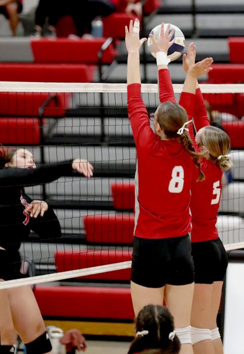A block by Jessalyn Fay #8 and Cadence Swanson #5 against their opponent.