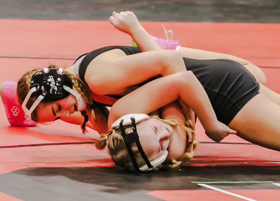 Danika Janssen works to keep her opponent pinned to the mat. Photos by Karen Phillips