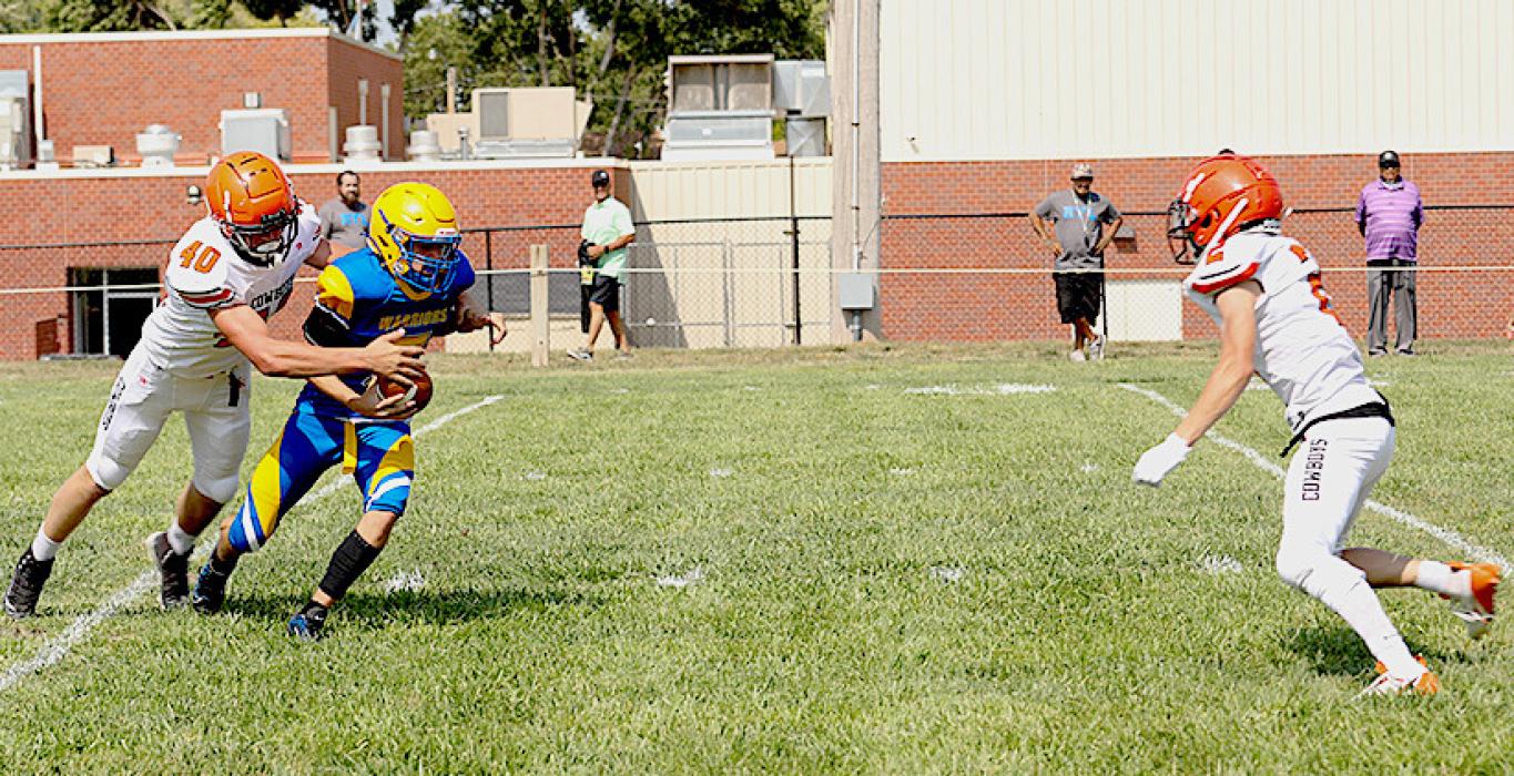 Cooper Pitkin #40 gets a hand on the Santee quarterback with help coming from Kaden McNare #2. Photos by Shontell Rosberry