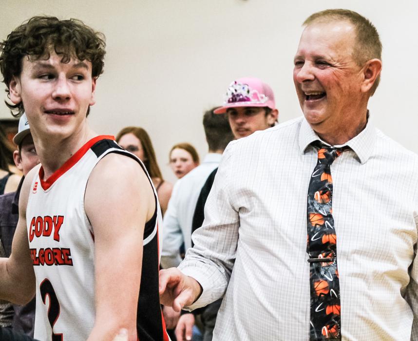 Happy Coach! CK senior Tristan Fish celebrating with head coach Scott Kuhn after defeating the Hay Springs Hawks 65-63 in Cody.
