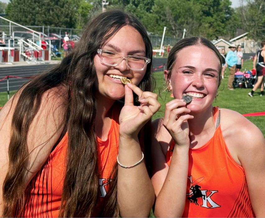 CK Freshmen Aubryanna Schmit and Lilly Ravenscroft celebrate qualifying for the State Championships with their district medals. Schmit won the discus and shot put, while Ravenscroft earned a second-place finish in the 1600M. They competed at NSAA State Track and Field May 23-24. Photo by Bentley Jenkins