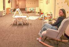 Jill Austin reclines in a rocker in the newly opened Heart City Childcare located in the basement of St. John’s Episcopal Church. Photo by Tina Boone