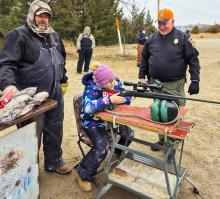 Conservation Officer Frank Miller helping shooter Makinley Hendrix. Her dad, Matt Hendrix, is supervising.