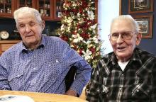 Gilbert Witte and Richard “Dick” Steifel - Reminiscing over their photos of the Korean War Photo by Tina Boone