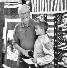 Will Cox awarded a quilt to Dick Jeffers. `