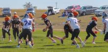 CK freshman quarterback Bentley Ford #4, handing off the football to junior Tripp Hill #11,with freshman Knox Wobig #10, as a lead blocker in action against the Arthur County Wolves.