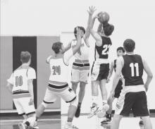 Photos by Shontell Roseberry Cooper Fay #10, Tucker Ravenscroft #24, and Jacob Knox #4, attempt a block against Sioux County.