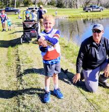 Oscar Daugherty shows off his fish during Kids Fishing Day at the Fish Hatchery ponds. Nice catch! Photo by Jean Burge