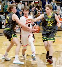 Cooper Fay #10 drives through two Hay Springs defenders to draw the foul and shoot two. Photos by Shontell Roseberry