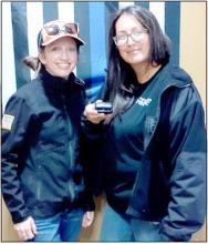 Valentine Police Officer Jasmine Hoefs and Staff Administrative Assistant Bobbi Johnson with a Guardian Angel personal wearable lighting device.