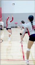 Kimber McGinley prepares to set to either Savannah Fullerton or Ariana Blume in the game against Coazd.