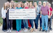 Pictured at the check presentation are back row, L to R: Steve Isom, Kim Shaul, Brandi Thornton, Kristin Jerred, Steve Brown. Middle row, L to R: Heather Stumpff, Annie Osnes, Deb Delaney, Sarah Danielski, S. Rourke Springer, Joan Johnson. Front row, L to R: Taylor Schendt, PA-S, Claire Carr, PA-C, Dr. Madeleine Wilson, Hannah Harwager, Talia Benson, Lacey Joseph, Lew Johnson. Photo by Laura Vroman